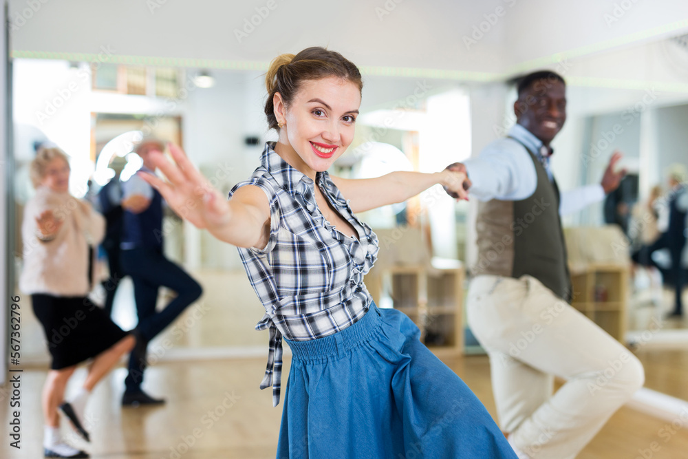 Man and woman performing jazz dance in dancing room Man and woman performing jazz dance in dancing room