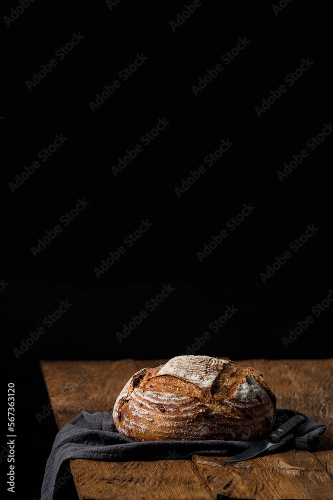 Rustic crispy sourdough bread with cranberries on a wooden table. Vertical panoramic view, free space for text Rustic crispy sourdough bread with cranberries on a wooden table. Vertical panoramic view, free space for text