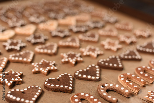 Rows of ginger cookies shaped like hearts, stars, and horseshoes. Valentine's Day, Christmas background. Selected focus.