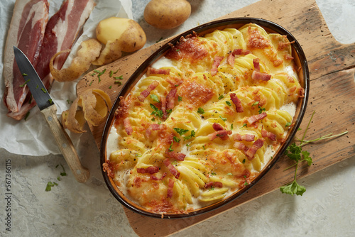 Delicious homemade dish with potato and cheese decorated with bacon