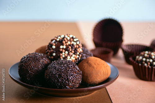 Traditional brazilian sweet chocolate ball Brigadeiro made with cocoa powder and condensed milk photo