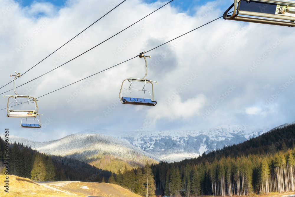 Ski lift on the background of snow-capped mountains