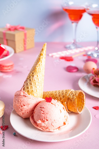 Pink ice cream cones with red sugar hearts shaped sprinkles. Valentines day concept.