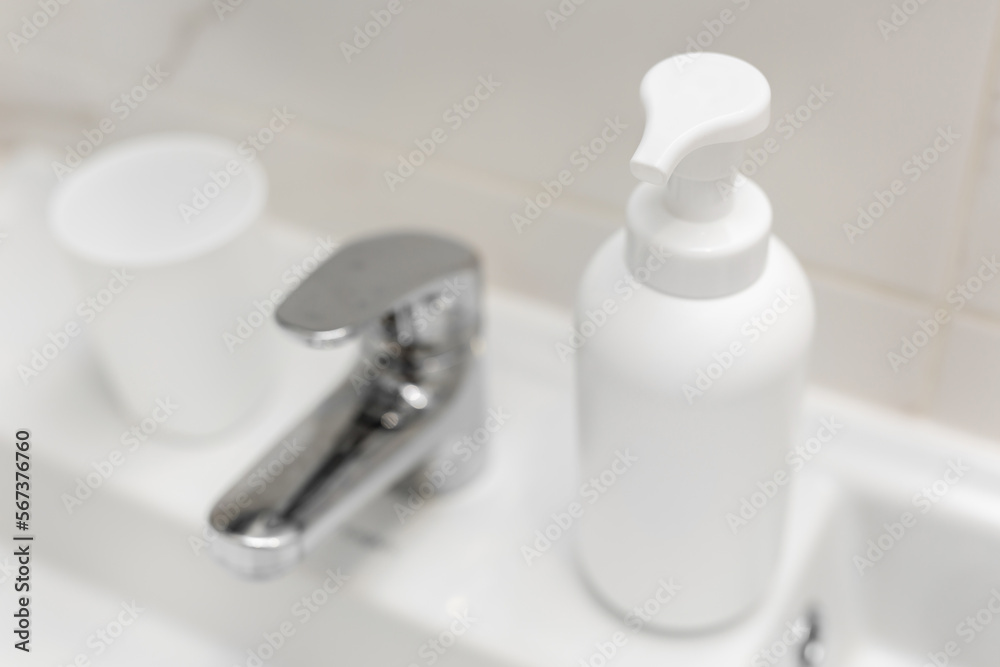 Faucet and white sink in a modern bathroom. Faucet and white sink in a modern bathroom.
