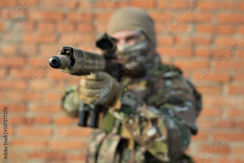 The muzzle of the machine gun is aimed at the enemy in close-up.