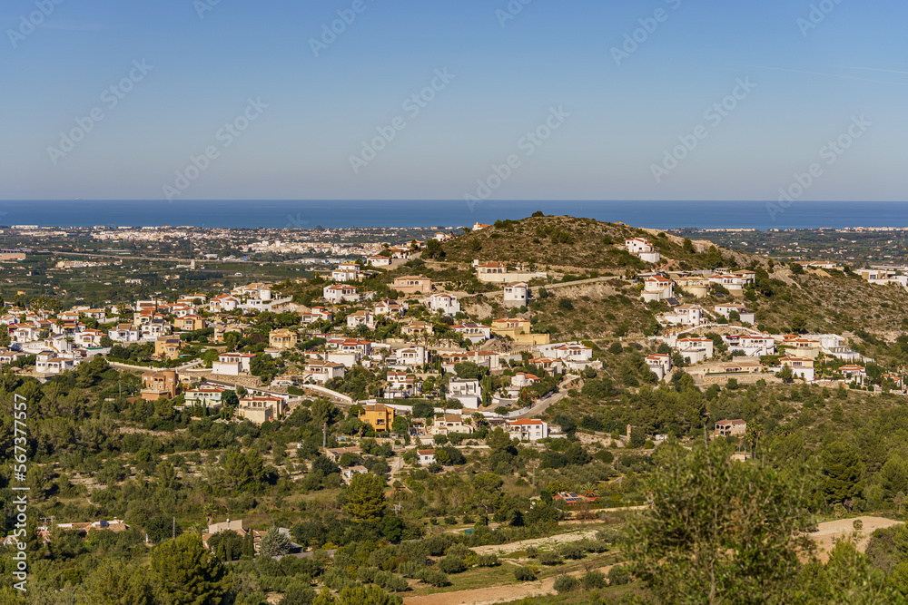 Beautiful panorama overlooking a distant town with the sea and forest in the background