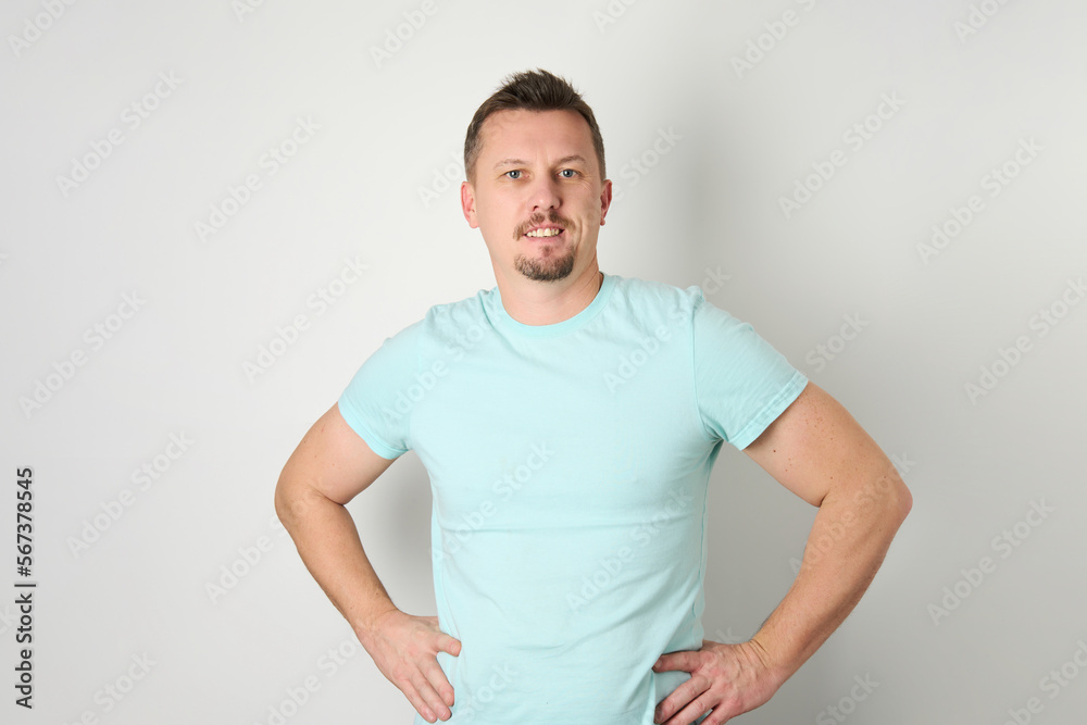 Handsome man posing with arms on hip