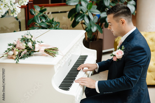 young groom performs on a white piano