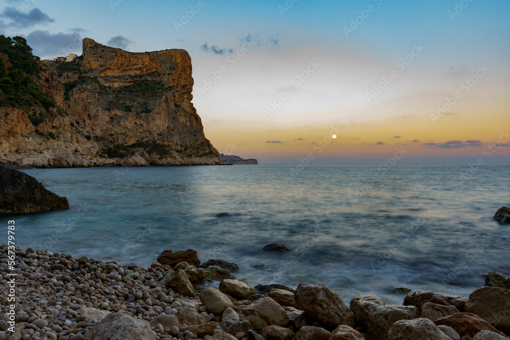 Beautiful sunset over the sea overlooking rocky beaches and steep rocky cliffs