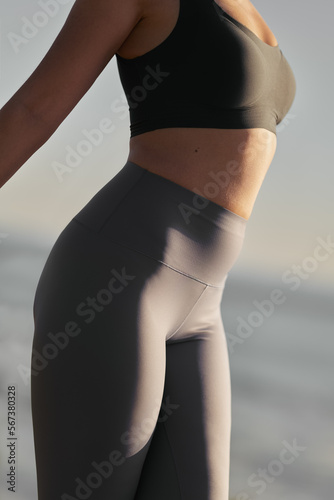 Crop fit sportswoman stretching body during outdoor yoga session