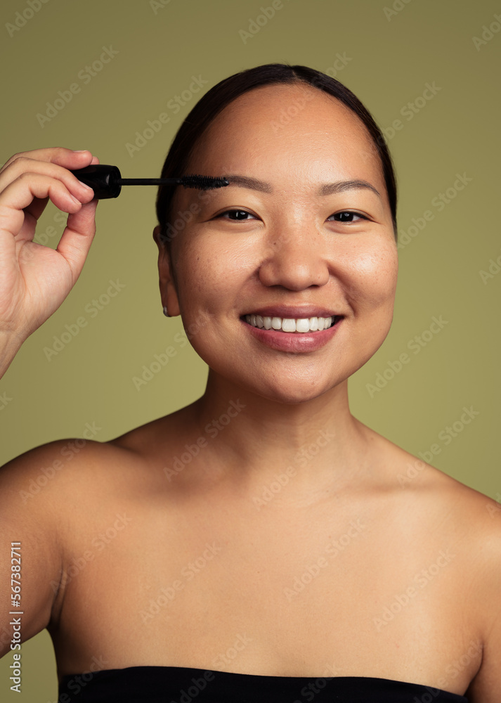 Fototapeta premium Optimistic Korean woman coloring eyebrow