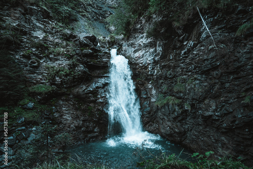 Fototapeta Naklejka Na Ścianę i Meble -  Majestic waterfall surrounded by trees in the Alps