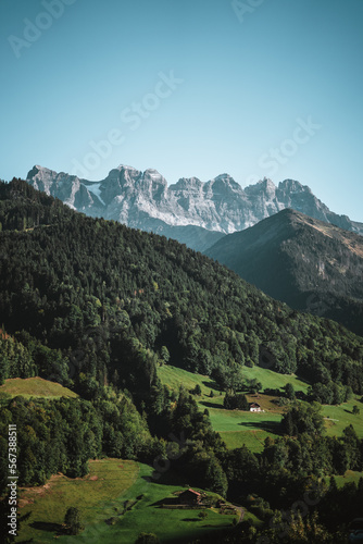 Majestic mountains in the Alps covered with trees and clouds