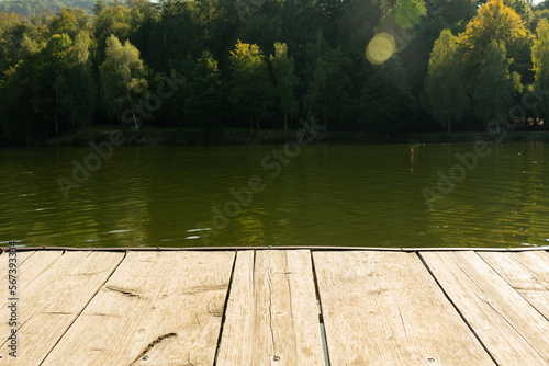 Fototapeta Naklejka Na Ścianę i Meble -  Close-up of dock near lake with forest background
