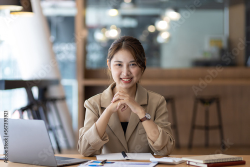 Portrait of an attractive smiling Asian businesswoman happy in the office.