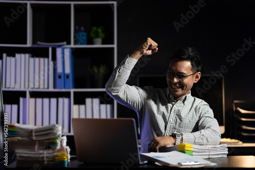 Responsible businessman working in night office trying overtime to achieve success of business project. Business people who have achieved success through hard work.