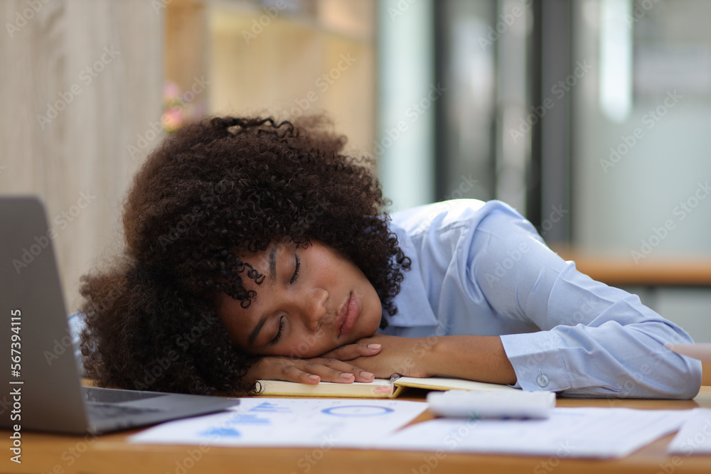 African woman sleepy at work time and exhausted from overwork in the office.