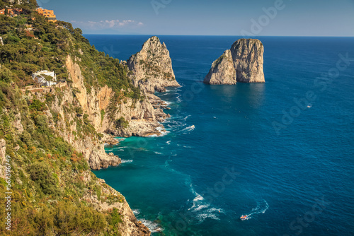 Above Capri city cliffs and Faraglioni with boats and yacht, amalfi coast, Italy