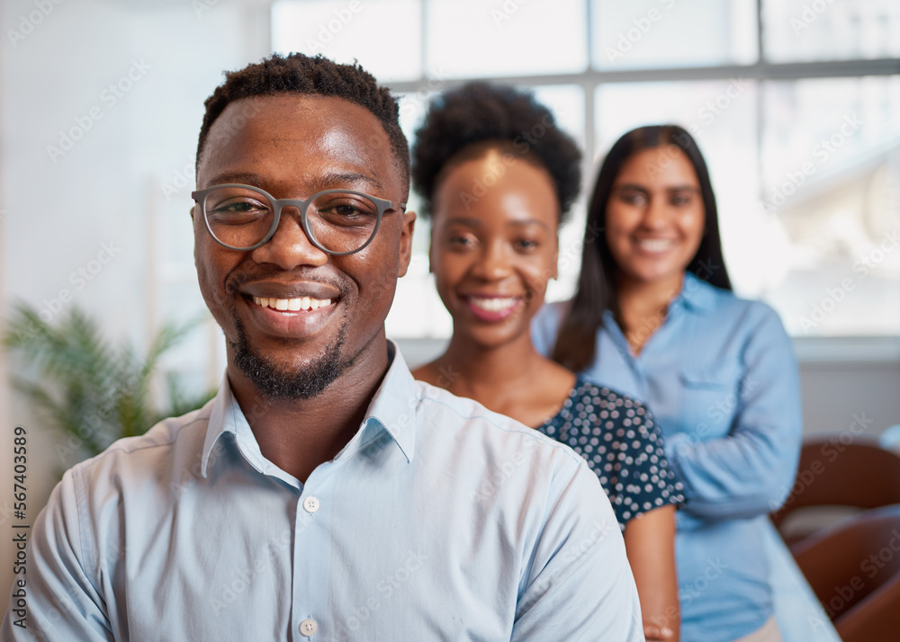 Trio of diverse business people lined up for portrait, focus on Black man Trio of diverse business people lined up for portrait, focus on Black man