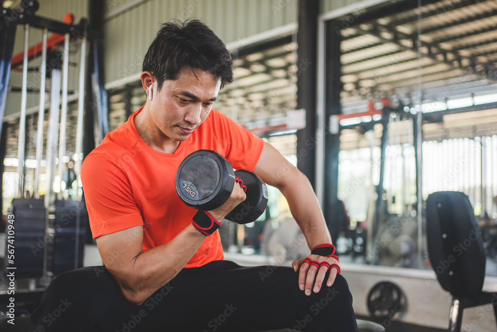 young man working out with dumbbells in the gym young man working out with dumbbells in the gym