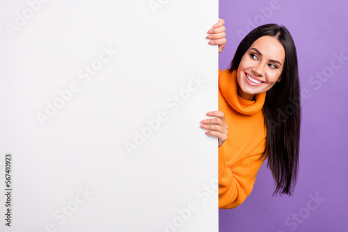 Photo of positive lady look copy space white billboard advertise shopping ads isolated on purple color background