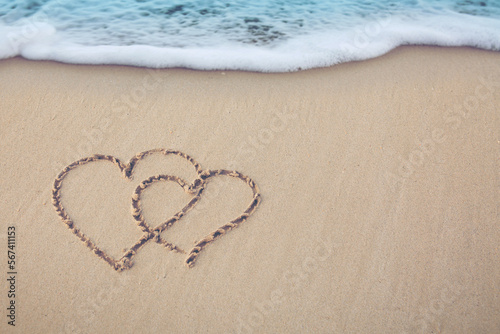 Fototapeta Naklejka Na Ścianę i Meble -  Two hearts of love on the sand by the caribbean sea.