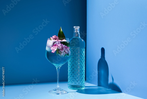Glass of cocktail near crystal bottle photo