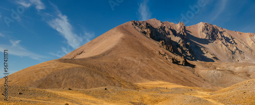 Amazing panoramic landscape of Mount Erciyes. View of the an inactive volcano: mountain range, stony slopes, rocky peaks formed by lava flows. Kayseri Province, Turkey.