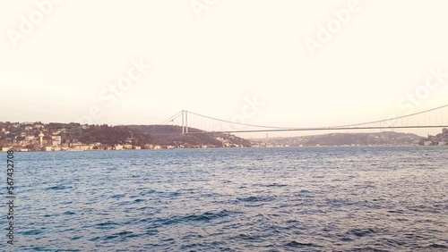View of the bosphorus strait in Istanbul, featuring the famous suspension bridge Bosphorus bridge or 15 july matrys bridge. Low light sunset footage recorded in Besiktas photo
