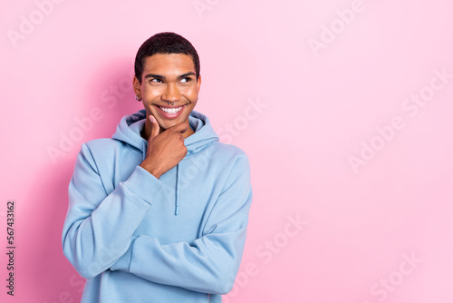 Photo of cheerful minded person arm touch chin beaming smile look interested empty space ad isolated on pink color background