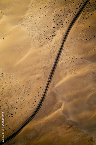 curvy road in the sand desert in fuerteventura (aerial view)