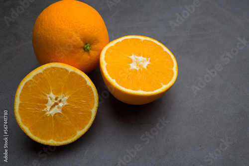 Fresh ripe orange on dark stone background. Top view