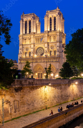 Notre-Dame de Paris cathedral and Cite island embankment at night, France
