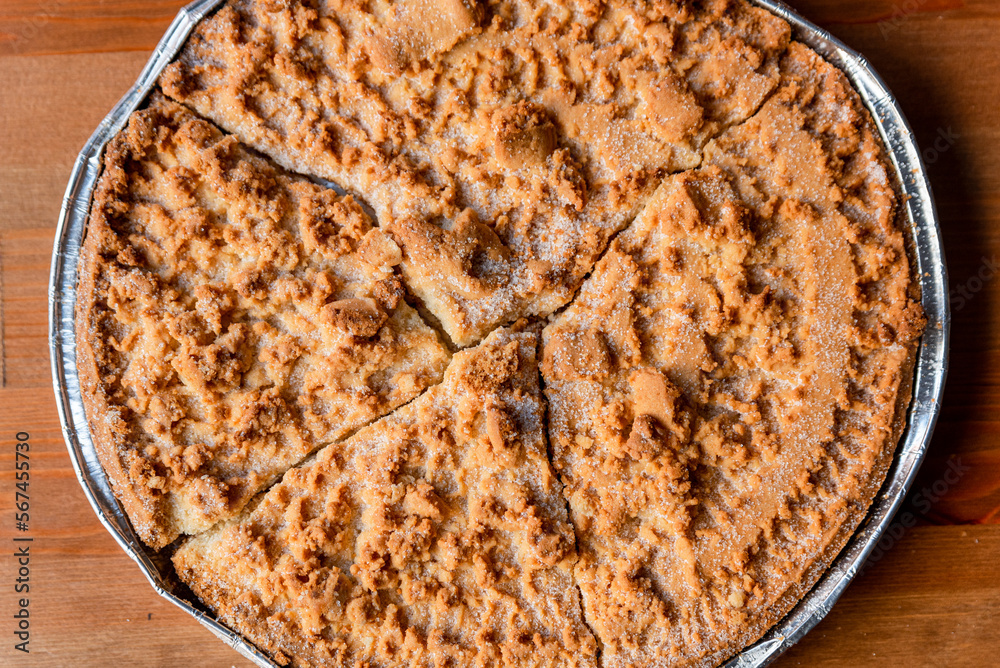 Fregolotta, a traditional italian crumb cake or pie is seen from top on a table. Traditional dessert from the Veneto region and Venice, made with flour, eggs, butter, sugar. Fregolotta, a traditional italian crumb cake or pie is seen from top on a table. Traditional dessert from the Veneto region and Venice, made with flour, eggs, butter, sugar.