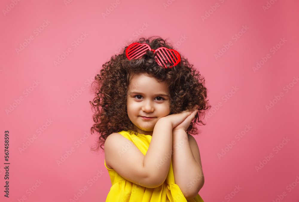 portrait of a girl in a yellow dress cute attractive cute cheerful cheerful little girl .isolated pink background. portrait of a girl in a yellow dress cute attractive cute cheerful cheerful little girl .isolated pink background.
