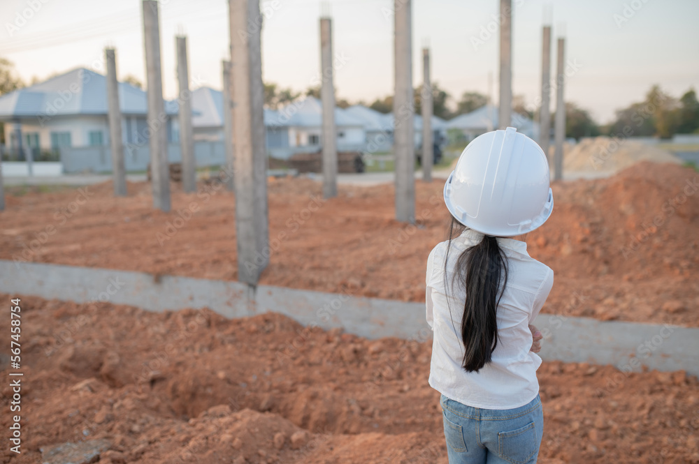 Engineer kid concept,Asian little girl wear engineer uniform working at site of building Engineer kid concept,Asian little girl wear engineer uniform working at site of building