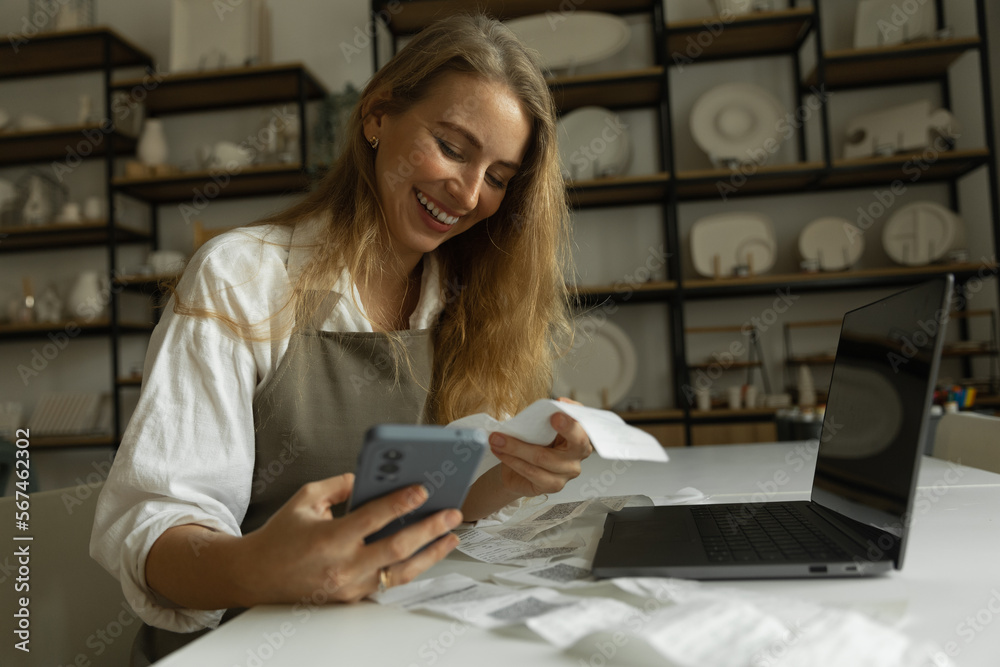 the girl pays checks through the application, small business, online tax payment,lifestyle photo the girl pays checks through the application, small business, online tax payment,lifestyle photo