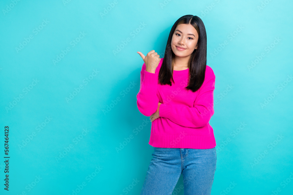 Fototapeta premium Photo of young confident korean lady wear pink knitted jumper directing finger empty space useful tips promo isolated on aquamarine color background