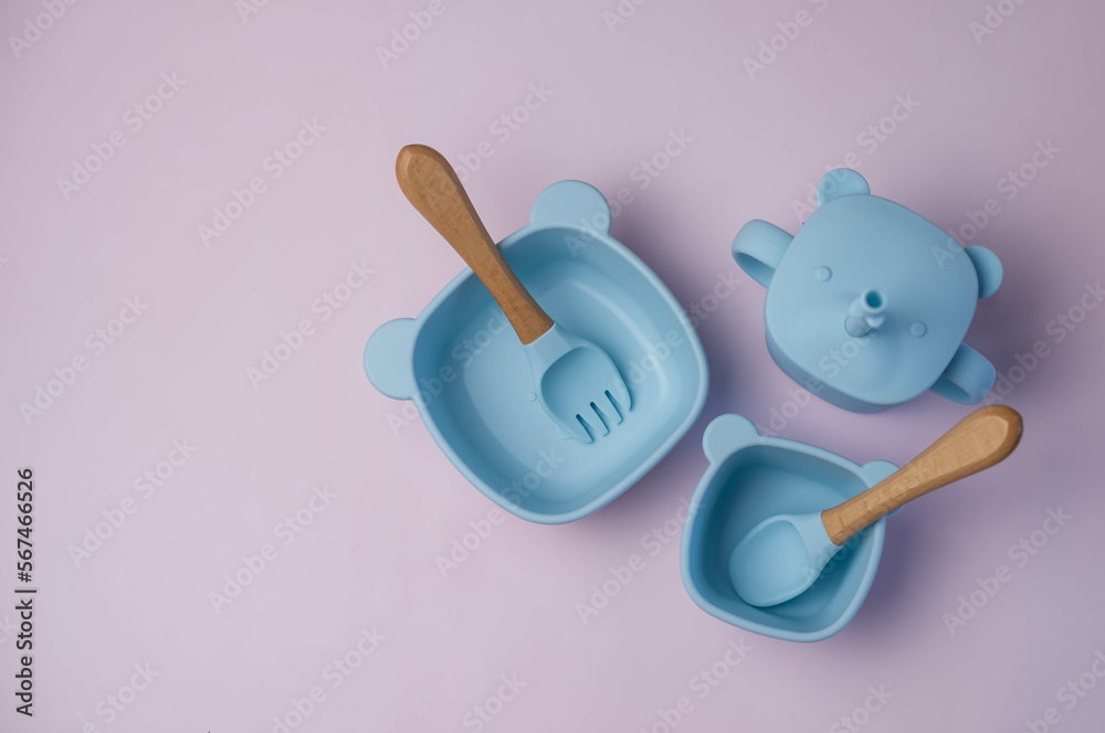 A set of children's silicone dishes. Baby feeding and nutrition concept. Top view, flat lay.