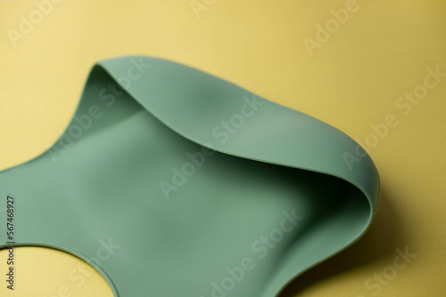 Details of a silicone bib for babies. Baby feeding and nutrition concept. Top view, flat lay. Close-up.