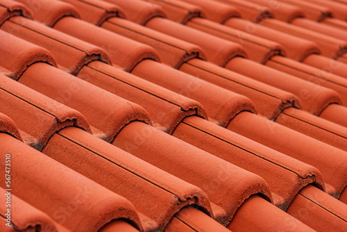 Red ceramic tiles on the roof of the house.