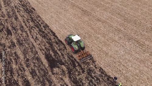 Tractor working in the field. Autumn tillage. Deep ripping with powerful tractor photo