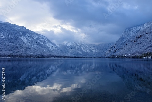 View of Bohinj lake in Gorenjska, Slovenia in winter with forest covered mountains in Julian alps © kato08