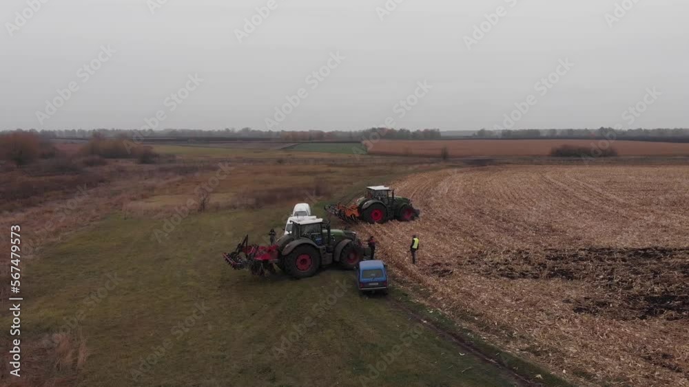Tractor working in the field. Autumn tillage. Deep ripping with powerful tractor Tractor working in the field. Autumn tillage. Deep ripping with powerful tractor