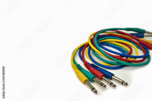 Multicolored audio cables, audio jack plug on white background. Headphone jack in different colors for connecting to a music device.