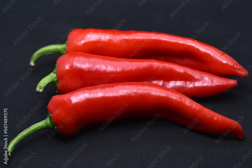 Large red capsicum on a black background. Hot red pepper. Capsicum.