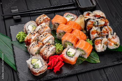 Big set of Asian food. Sushi and rolls on a dark background.