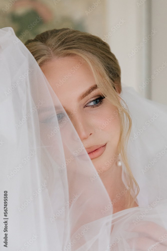 Morning preparations of a beautiful, sexy bride with a wedding bouquet in lingerie, a bathrobe in a hotel, where she puts on shoes in a wedding dress Morning preparations of a beautiful, sexy bride with a wedding bouquet in lingerie, a bathrobe in a hotel, where she puts on shoes in a wedding dress