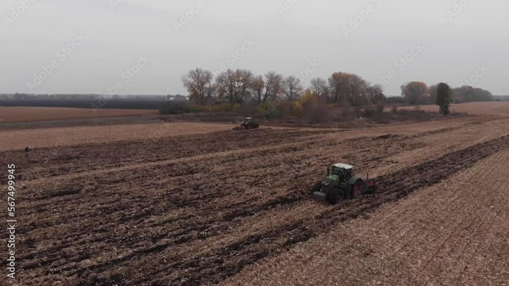 Tractor working in the field. Autumn tillage. Deep ripping with powerful tractor Tractor working in the field. Autumn tillage. Deep ripping with powerful tractor