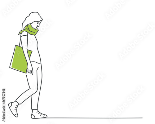 Young woman walks slowly with her head down, carries a bag.